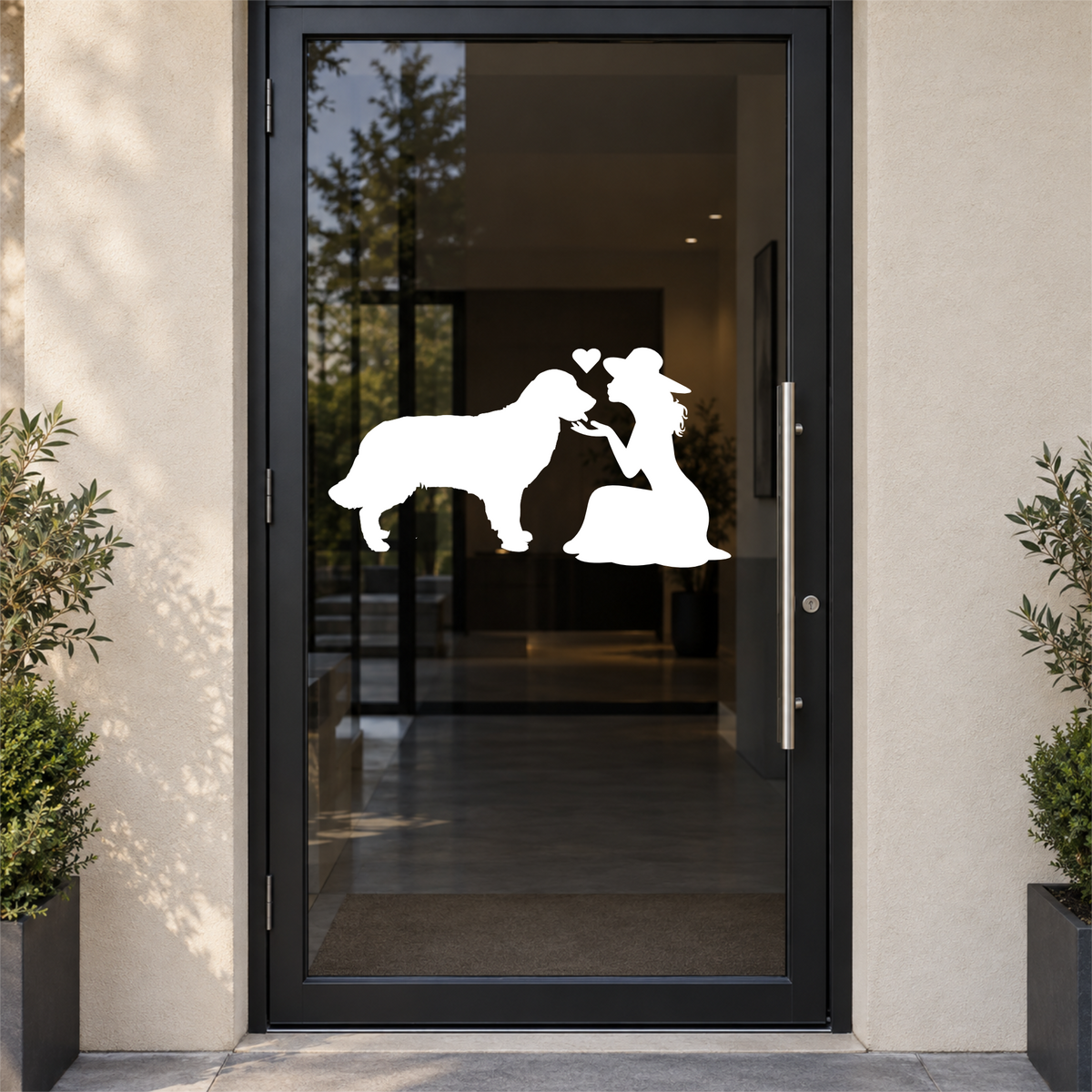 White lady and dog silhouette cut vinyl decal shown on a smoky glass door
